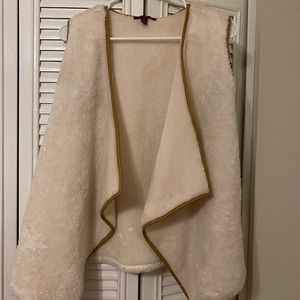 White furry vest with leather trim